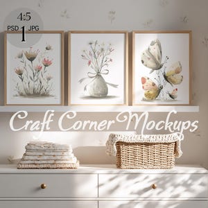 May include: Three framed watercolor art prints featuring floral and butterfly designs. The prints are displayed on a white shelf above a white dresser. A woven basket and folded linens are on the dresser. The text "Craft Corner Mockups" is below the shelf.