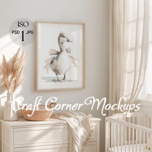 May include: A framed watercolor print of a goose wearing a pink bow. The artwork is displayed on a light-colored wall. The image is part of a mockup with the text "Craft Corner Mockups".