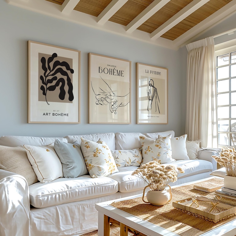 May include: Three framed art prints on a light blue wall. The prints feature abstract line drawings and the text "Art Boh&egrave;me", "Galerie Boh&egrave;me", and "La Femme".