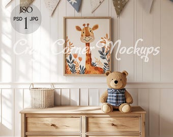 May include: A wooden dresser with four drawers in a nursery setting. A framed print of a giraffe with a floral background hangs on the wall above the dresser. A stuffed teddy bear sits on top of the dresser. A basket sits on the floor next to the dresser.