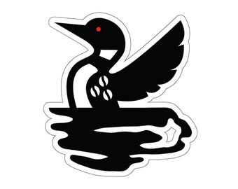 May include: Black and white silhouette of a loon with red eyes, flying over a body of water. The loon is stylised and has a simple design.