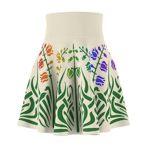 May include: A cream-coloured skirt with a rainbow floral print. The flowers are stylised and have a green stem and leaves. The skirt has a flared silhouette.