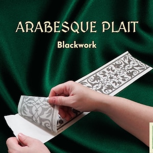 May include: A roll of blackwork patterned adhesive paper with a gray and white design. The paper is being peeled off of a white backing. The text "Arabesque Plait Blackwork" is visible at the top of the image.