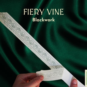 May include: A white paper pattern with a blackwork design of a vine with leaves. The pattern is labelled "FIERY VINE Blackwork" and has the text "Fiery Vine © 2023 The Haunted Stitcher For personal use only".