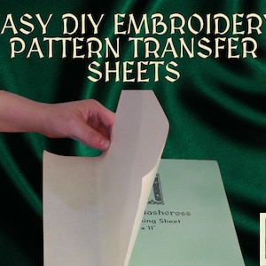 May include: A white embroidery transfer sheet being peeled off a green background. The sheet is labelled "Washercross Tracing Sheet 11" x 11"