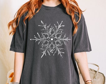 May include: A dark gray oversized t-shirt with a white snowflake graphic printed on the front.