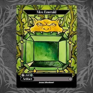 May include: A green gemstone with a gold border, surrounded by vines. The text "Mox Emerald" is at the top of the card. The card also says "Artifact" and "Add: {G}".