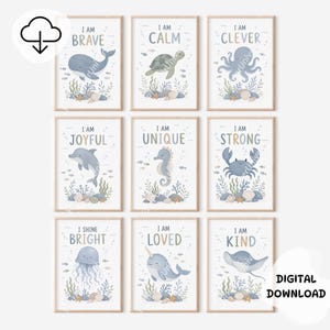 May include: A set of nine framed wall art prints featuring watercolor sea creatures including a whale, turtle, octopus, dolphin, seahorse, crab, jellyfish, narwhal, and stingray, each with text such as I AM BRAVE, CALM, CLEVER, JOYFUL, UNIQUE, STRONG, BRIGHT, LOVED, and KIND.