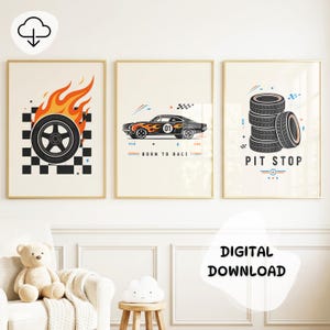 May include: Three framed wall art prints featuring racing themes. The first shows a tire with orange flames over a black and white checkered pattern. The second depicts a black car with flames and the text BORN TO RACE. The third shows a stack of tires with the text PIT STOP.