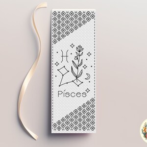 May include: A black and white cross-stitch pattern for a bookmark featuring the Pisces zodiac sign, a flower, and the word "Pisces".