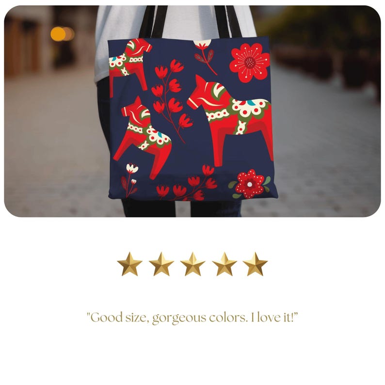 May include: A navy blue tote bag with a repeating pattern of red and white Dala horses and floral designs.