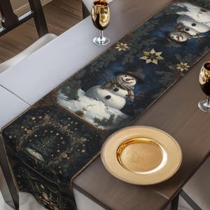 May include: A wooden dining table set for a holiday meal. A dark blue table runner with snowmen and gold stars is centered on the table. Gold-rimmed wine glasses and a gold plate are set for each guest. Red roses are in a gold bowl.