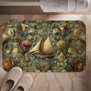 May include: A rectangular bath mat featuring a vintage illustration of a sailboat on a sea of blue, surrounded by floral and botanical elements in shades of cream, peach, and green. The mat is placed on a tiled floor, with a pair of beige slippers visible.
