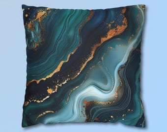 May include: A square throw pillow featuring a fluid, marbled pattern in shades of deep teal, navy blue, and white. The design is accented with metallic gold veins and speckled gold leaf details that flow across the surface in a wavy, organic motion.