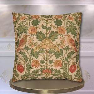 May include: Square decorative pillow with a floral and bird pattern. The pillow features a cream background with green leaves, orange flowers, and two birds. Red strawberries are also part of the design. The pillow is likely for home decor.