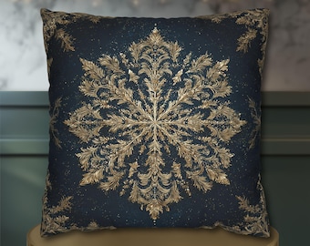 May include: A square throw pillow featuring a dark navy blue background with a large, intricate, gold-colored snowflake design in the center. The snowflake pattern is composed of detailed, leafy, and ornate filigree elements.