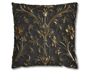 May include: A square throw cushion featuring a dark charcoal grey background with a symmetrical, raised metallic gold floral pattern. The design consists of intricate, flowing vines, leaves, and blooming flowers that create a repeating motif.