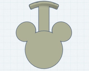 May include: A beige, 3D printed, mouse-shaped keychain with a loop on top. The keychain is designed to look like Mickey Mouse.