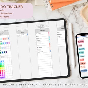 May include: A digital to-do tracker displayed on a tablet and smartphone. The tablet shows a detailed task list with color-coded categories and a date field. The smartphone displays a simplified version of the task categories. The text on the tablet reads "TO DO TRACKER".