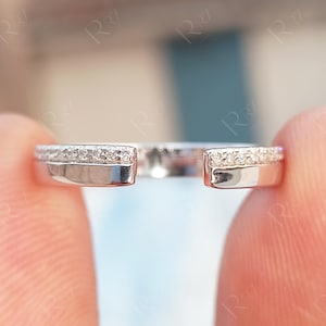 May include: A white ceramic mug with a black handle and the text "But First, Coffee" in a handwritten style. The mug is on a white surface. The mug is approximately 4 inches tall.