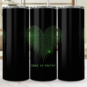 May include: A black cylindrical tumbler with a silver lid and straw. The design features a heart shape formed by cascading green digital binary code on a black background. Below the heart, the text CODE IS POETRY is printed in green.