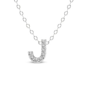 May include: A silver necklace with a pendant in the shape of the letter J. The pendant is covered in small, clear diamonds.