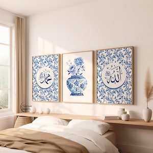 May include: Three framed prints with a blue and white floral design. One print features a blue vase with flowers, while the other two display Arabic calligraphy. The prints are displayed above a bed with a wooden headboard.