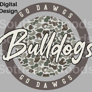 May include: A circular digital design featuring a camouflage pattern in shades of green, brown, and white. A dark brown border surrounds the circle with the text GO DAWGS in white. The word Bulldogs is written in a large, white, cursive font.