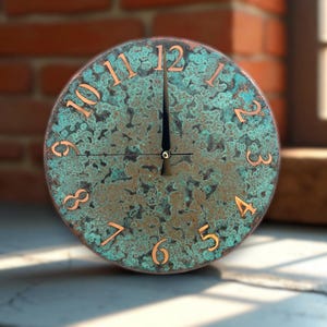 May include: A round clock with a weathered, turquoise-colored face and copper-colored numerals. The clock's hands point to approximately 12 o'clock. The clock is set against a blurred background of a brick wall and a window.
