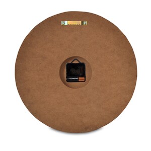 May include: The back of a round wooden clock with a battery compartment and a hanging hook.
