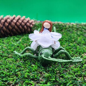 Whimsical Cute Green and White Miniature Flower Fairy Doll Riding Bug ...