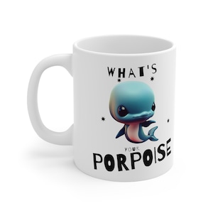 May include: White ceramic mug with a black and white graphic of a cartoon dolphin and the text "What's your porpoise".