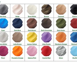 May include: A color chart displaying 3D printed PLA filament samples in various colors. Colors include Apple Green, Ash Grey, Beige, Bone White, Bronze, Caramel, Charcoal, Cobalt Blue, Cocoa Brown, Cyan, Dark Blue, Dark Brown, Dark Chocolate, Dark Green, Dark Red, Gold, Grass Green, Ivory White, Latte Brown, Lemon Yellow, Lilac Purple, Mandarin Orange, Marine Blue, Mistletoe Green, Nardo Grey, Plum, Pumpkin Orange, Sakura Pink, Scarlet Red, Silver, Sky Blue, Sunflower Yellow, and Terracotta.