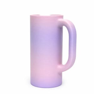 May include: A tall, cylindrical mug with a large handle. The mug features a gradient color scheme, transitioning from pink at the base to lavender at the top. The mug is made of a solid material and has a smooth finish.