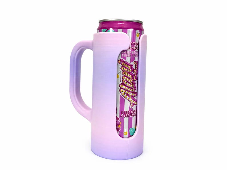 May include: A pink and purple ombre can cooler with a handle, holding a can of "Tutti Candy" energy drink. The can has a pink and white striped design with text. The cooler is designed to keep beverages cold.