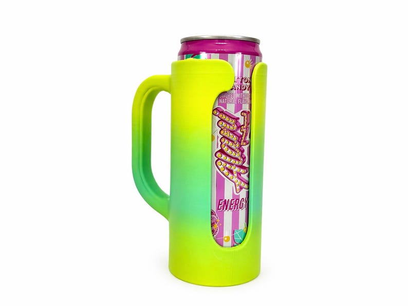 May include: A neon yellow and green insulated can cooler with a handle, holding a can of "Fruity" energy drink. The can has a pink and white striped design with the words "Cotton Candy" and "Energy" printed on it.