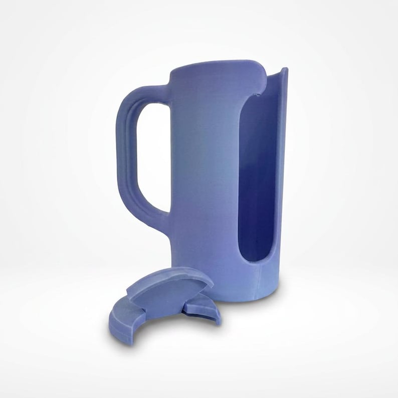 May include: A periwinkle-colored mug with a handle and a large opening on one side. A separate, matching lid is in front of the mug. The mug appears to be 3D-printed.