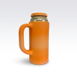 May include: Orange can cooler with a handle, designed to hold a standard-sized beverage can. The cooler has a cylindrical body and a curved handle for easy gripping. The top of the can is visible, with text that reads "Vanilla".