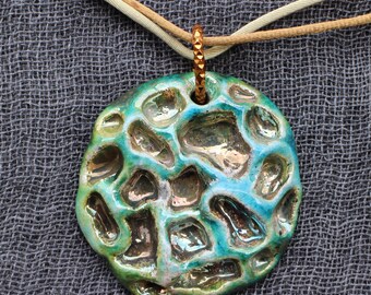 Raku ceramic pendant, gold, light green and turquoise colors