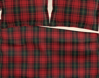 May include: A red, black, and green plaid bedding set. The set includes a duvet cover and two pillowcases. The plaid pattern is a classic design, with a repeating grid of lines in various colors. The bedding is made of a soft material.