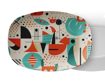 May include: An oval serving platter with a geometric pattern in shades of orange, teal, black, and white. The pattern includes circles, squares, triangles, and lines.