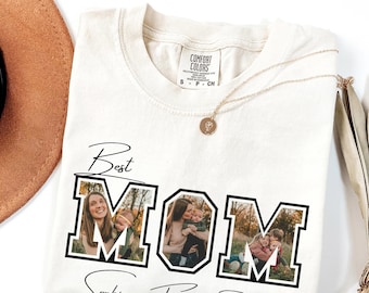 May include: A cream-colored short-sleeve t-shirt featuring the text Best MOM in black block letters. Each letter contains a different photograph of a person with children. Below the graphic, the names Sophia, Frank, and Rebecca are printed.
