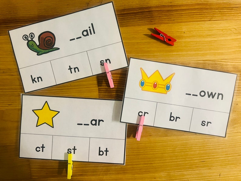 May include: Three printable cards with pictures of a snail, a star, and a crown. Each card has a word with a missing beginning sound and three options to choose from. The snail card says "--ail", the star card says "--ar", and the crown card says "--own".