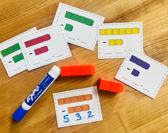 May include: Five printable worksheets with subtraction problems using coloured blocks. The worksheets have a line for the answer and a space for drawing the blocks. The image also shows a dry-erase marker and orange blocks.