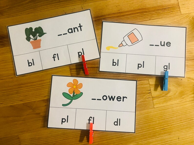 May include: Three white cards with black text and images. The first card has a picture of a plant and the text "_ant", "bl", "fl", and "pl". The second card has a picture of a glue bottle and the text "_ue", "bl", "pl", and "gl". The third card has a picture of a flower and the text "_ower", "pl", "fl", and "dl".