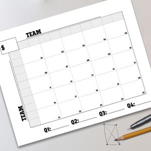 May include: A white paper calendar with a grid layout, featuring the word "TEAM" in bold black letters. The calendar includes numbered dates and spaces for quarterly entries. A pencil and pen are visible in the corner.
