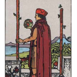 May include: A tarot card illustration featuring a figure in a red robe and cap standing on a stone balcony. The figure holds a small globe in one hand and rests the other on a tall wooden staff. A second staff stands nearby. The Roman numeral II is at the top.