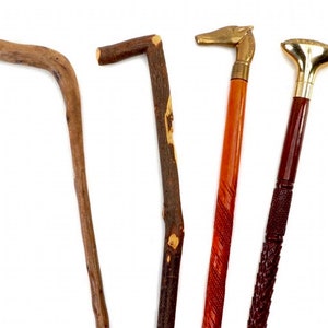May include: Four wooden walking sticks with different handles. One stick has a curved handle, one has a simple knob, one has a horse head handle, and one has a decorative knob.