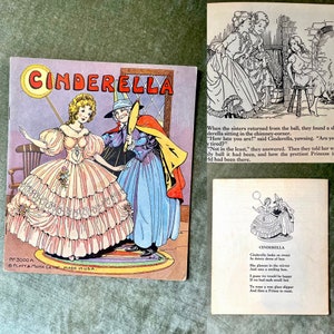May include: A vintage children's book illustration of Cinderella in a pink and white ball gown with a red and yellow cape. The text on the cover reads "CINDERELLA".