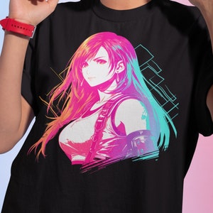 May include: Black t-shirt featuring a vibrant anime-style illustration of a female character with long, colorful hair. The artwork uses pink, blue, and yellow hues. The shirt is a classic crew neck style.